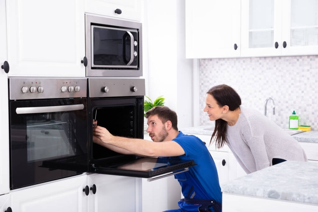 technician fixing the oven